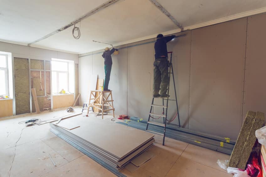 workers are installing plasterboard (drywall) for gypsum walls in apartment is under construction, remodeling, renovation, extension, restoration and reconstruction.